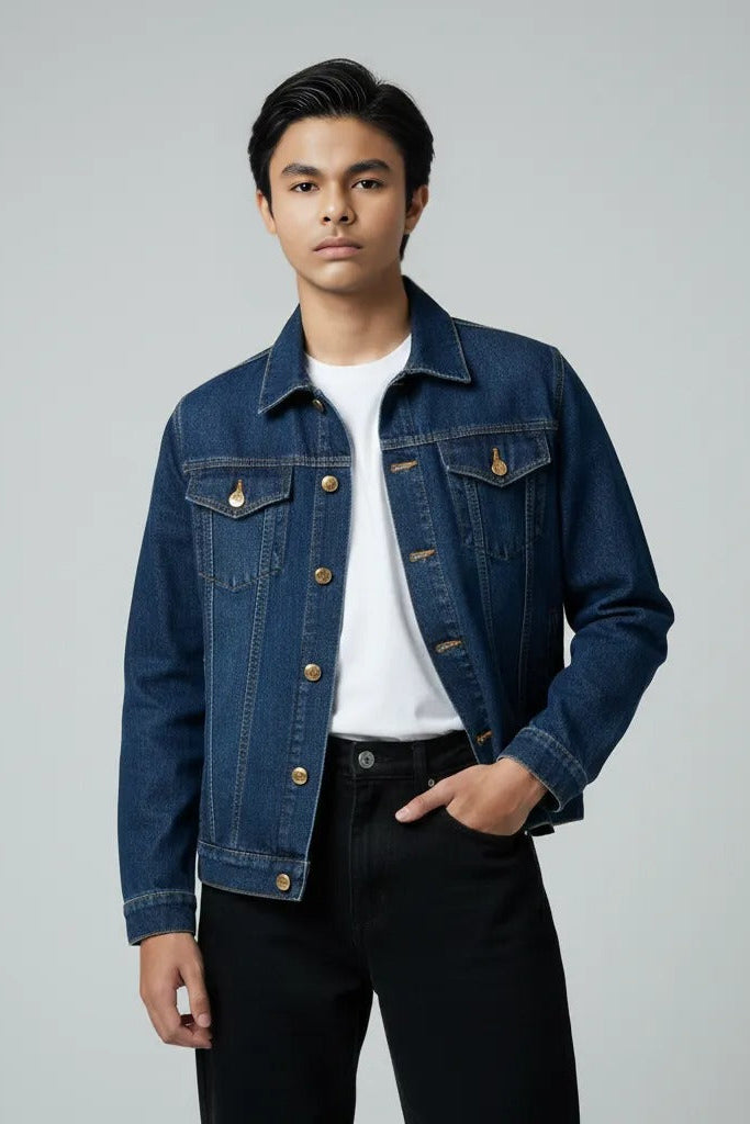 Man wearing a blue denim jacket over a white shirt on a gray background